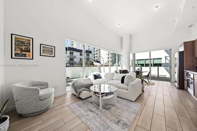 a living room with furniture and a large window