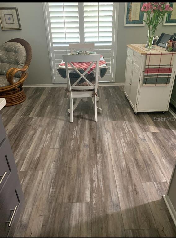 1609 Whitebridge Drive, Unit C Palm Harbor, FL 34684 - Photo 11 of 30 a chair and table in a room