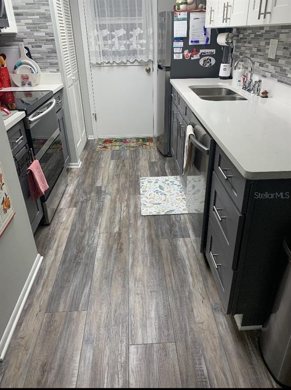 1609 Whitebridge Drive, Unit C Palm Harbor, FL 34684 - Photo 12 of 30 a utility room with sink dryer and washer