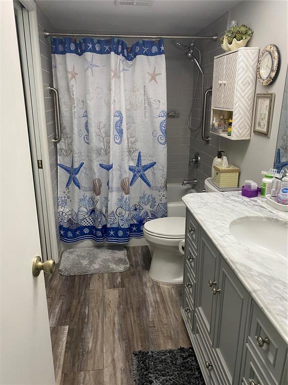 1609 Whitebridge Drive, Unit C Palm Harbor, FL 34684 - Photo 13 of 30 a bathroom with a granite countertop sink toilet and shower