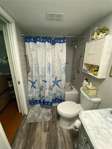 a bedroom with a bed mirror and a window