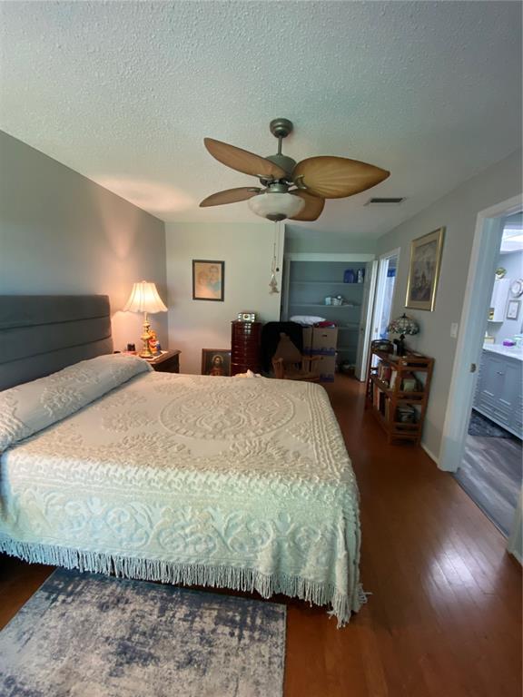 1609 Whitebridge Drive, Unit C Palm Harbor, FL 34684 - Photo 15 of 30 a bedroom with a bed mirror and a window