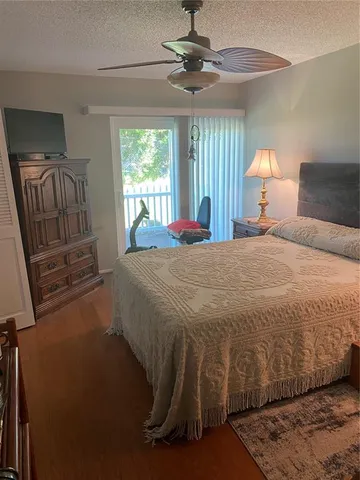 a bedroom with a bed and dresser with mirror