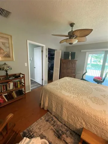 a bed room with a bed mirror and a chandelier