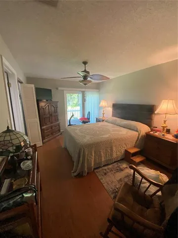 a bed room with a bed mirror and a chandelier