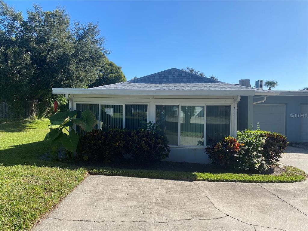 1609 Whitebridge Drive, Unit C Palm Harbor, FL 34684 - Photo 27 of 30 a front view of a house with garden