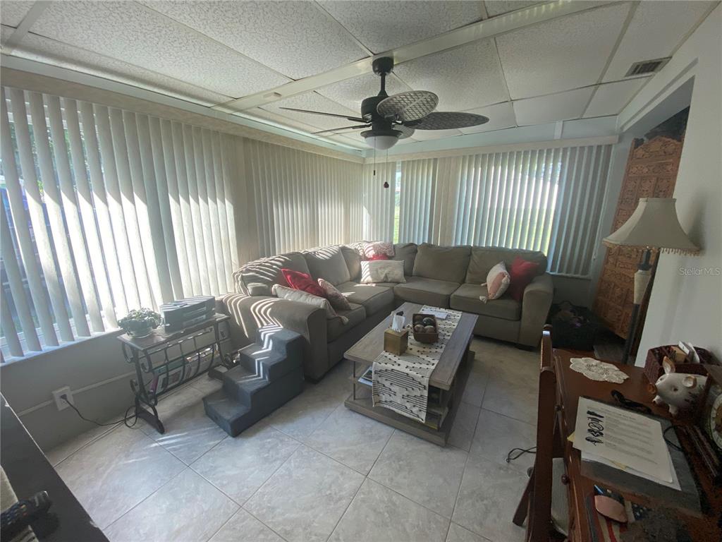 1609 Whitebridge Drive, Unit C Palm Harbor, FL 34684 - Photo 3 of 30 a living room with furniture and a window