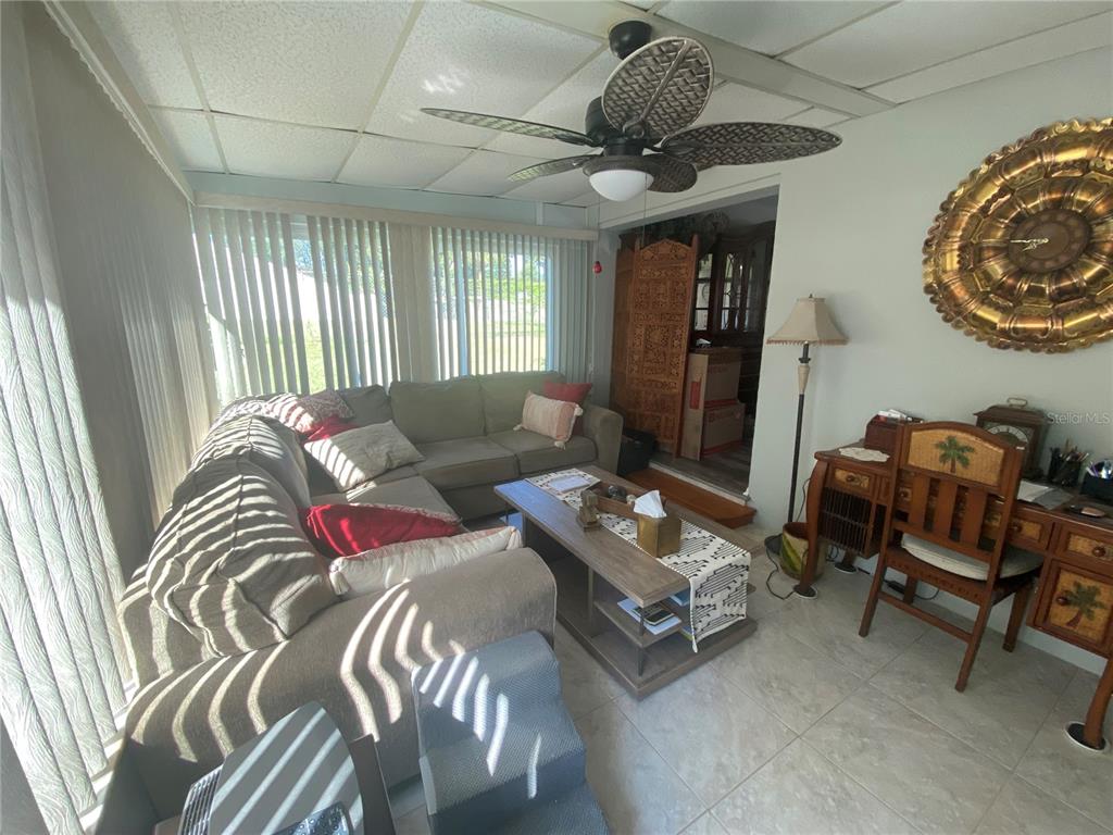 1609 Whitebridge Drive, Unit C Palm Harbor, FL 34684 - Photo 4 of 30 a living room with furniture and a large window