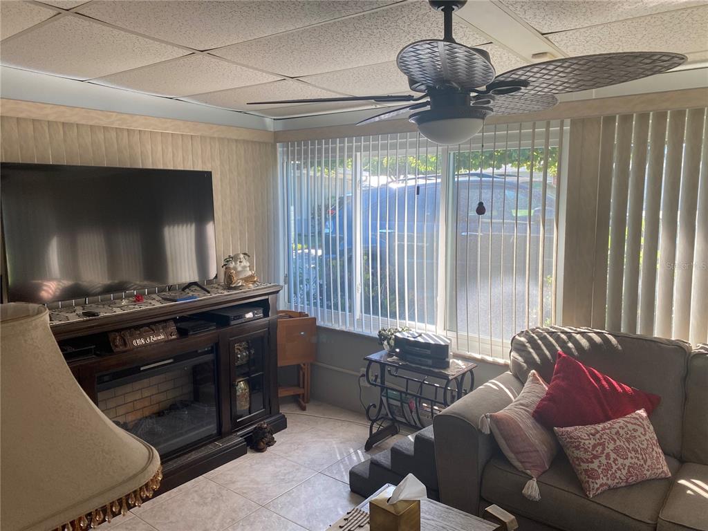 1609 Whitebridge Drive, Unit C Palm Harbor, FL 34684 - Photo 6 of 30 a living room with furniture and a flat screen tv