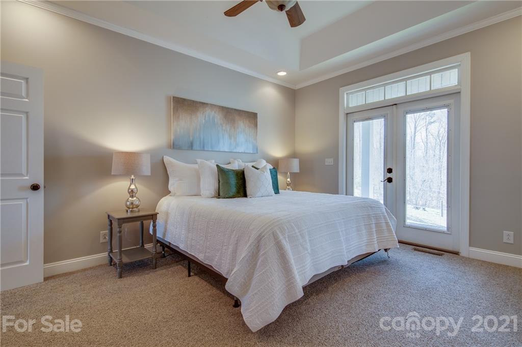 2460 State Rd S-46-883 York, SC 29745 - Photo 19 of 48 a spacious bedroom with a bed and a chandelier