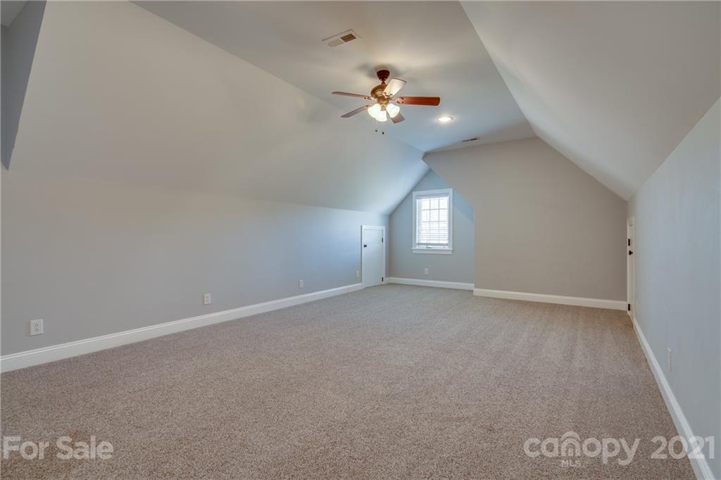 2460 State Rd S-46-883 York, SC 29745 - Photo 34 of 48 an empty room with a chandelier fan and windows