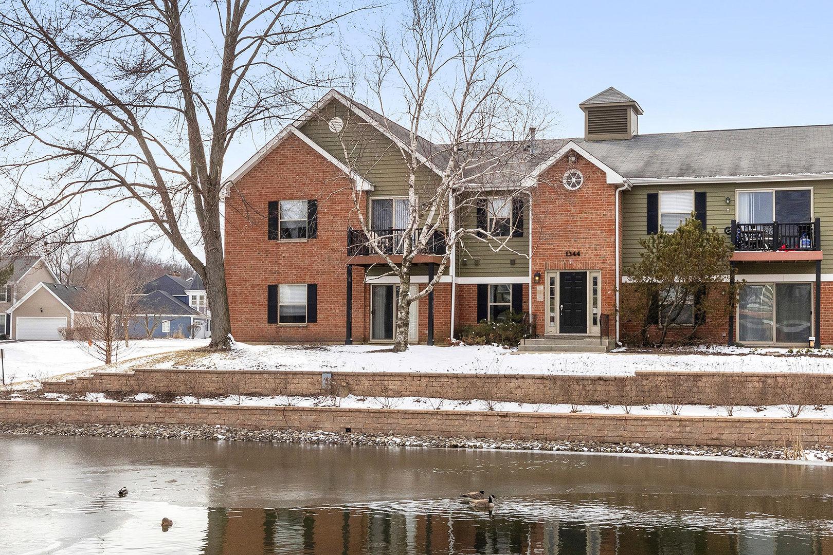 1344 McDowell Road, Unit 101 Naperville, IL 60563 - Photo 2 of 19 a front view of a house with a yard
