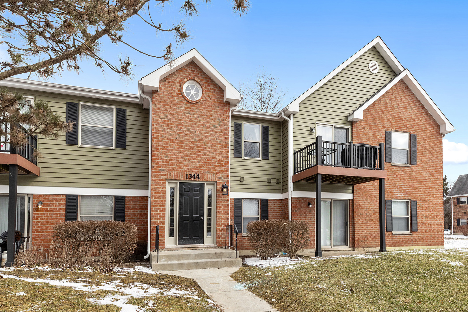 1344 McDowell Road, Unit 101 Naperville, IL 60563 - Photo 3 of 19 a front view of a house with garden