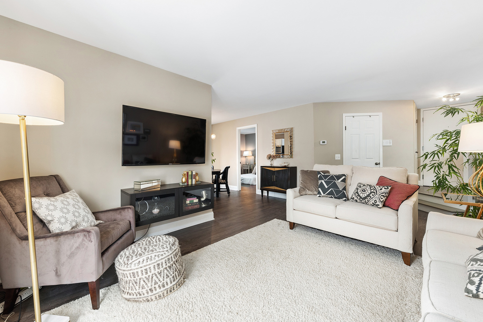 1344 McDowell Road, Unit 101 Naperville, IL 60563 - Photo 8 of 19 a living room with furniture and a flat screen tv