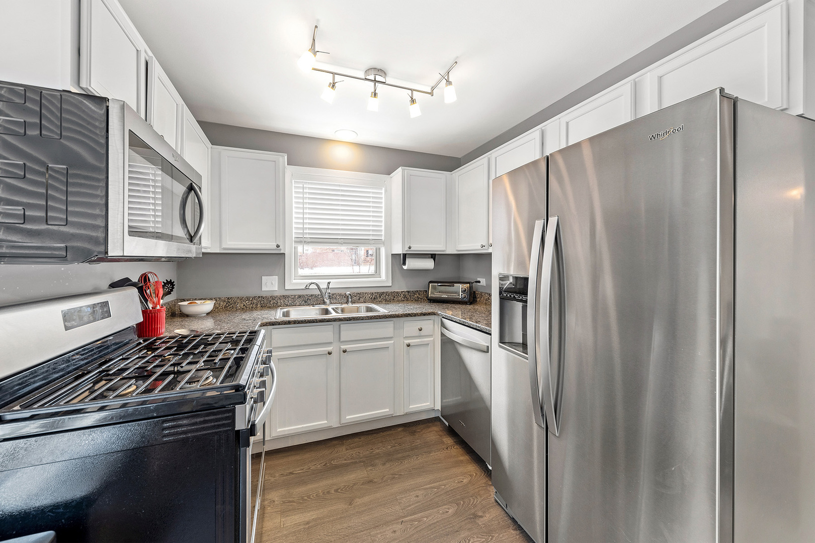 1344 McDowell Road, Unit 101 Naperville, IL 60563 - Photo 10 of 19 a kitchen with stainless steel appliances a refrigerator sink and cabinets