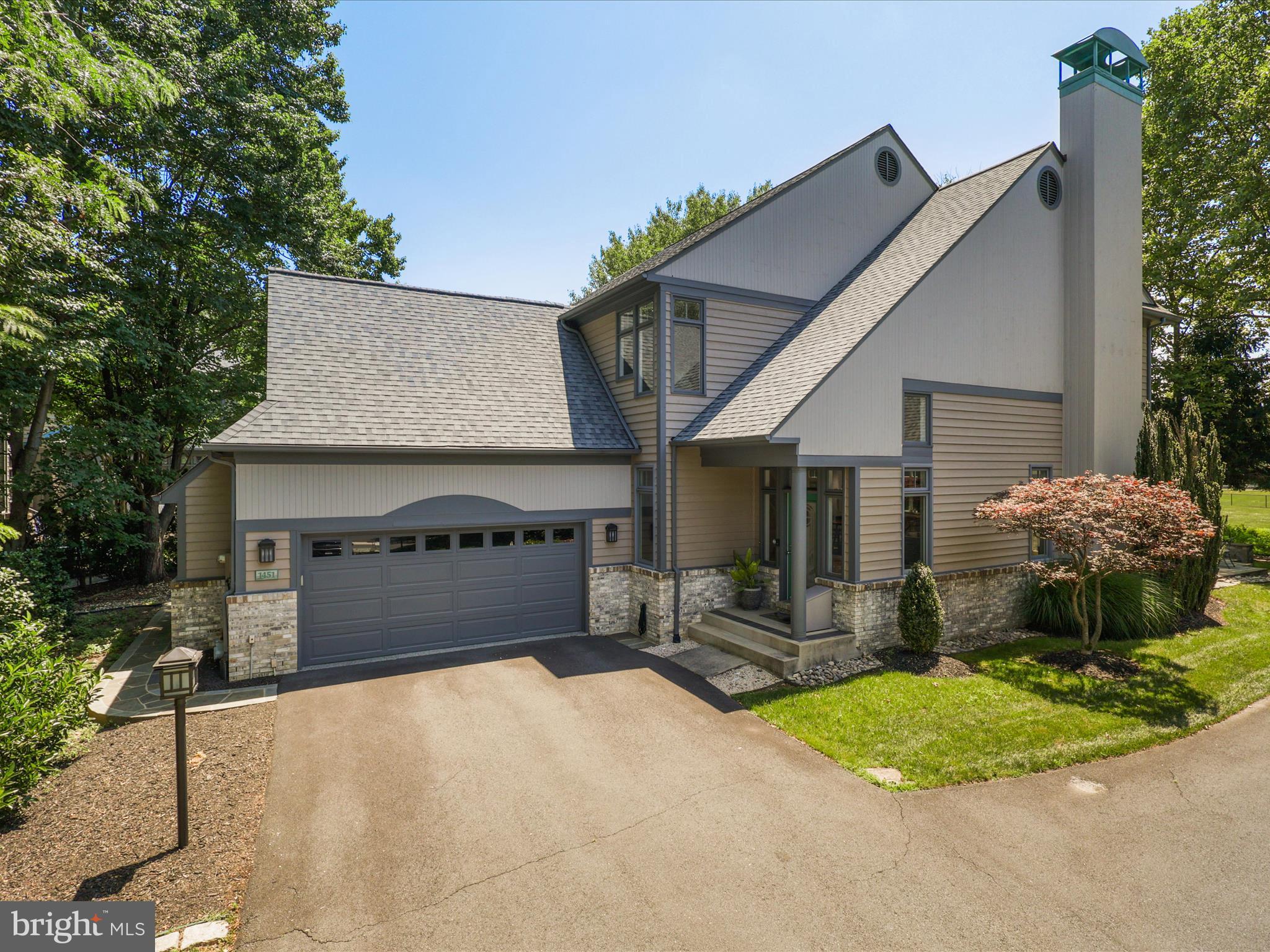 1451 Waterfront Road Reston, VA 20194 - Photo 3 of 76 a front view of a house with a yard and garage