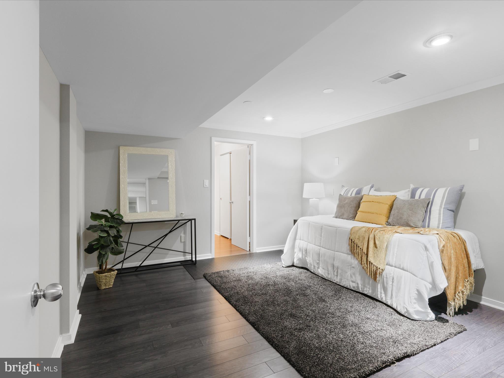 1451 Waterfront Road Reston, VA 20194 - Photo 44 of 76 a spacious bedroom with a bed and wooden floor