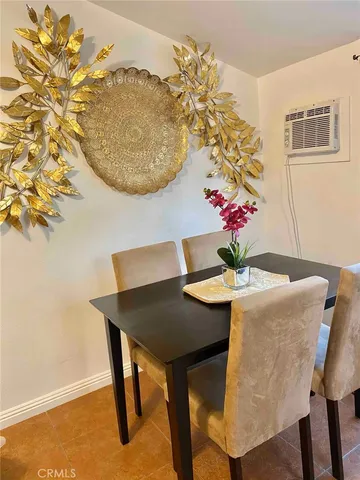 a bed sitting in a bedroom next to a window with a rug