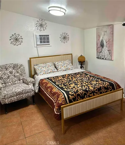 a bedroom with a bed and flat screen tv