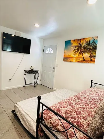 a bedroom with a large bed and a window