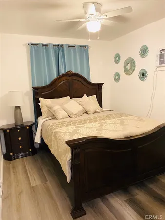 a bed sitting in a bedroom next to a window
