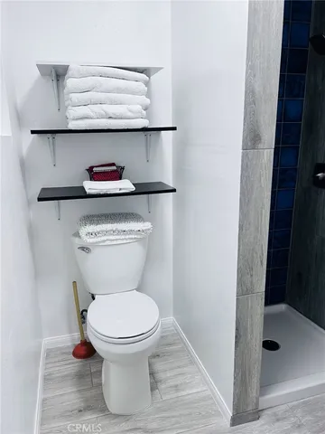 a bedroom with a bed and large windows