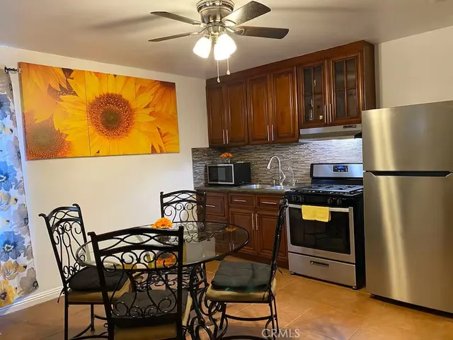 a kitchen with granite countertop cabinets stainless steel appliances and a sink
