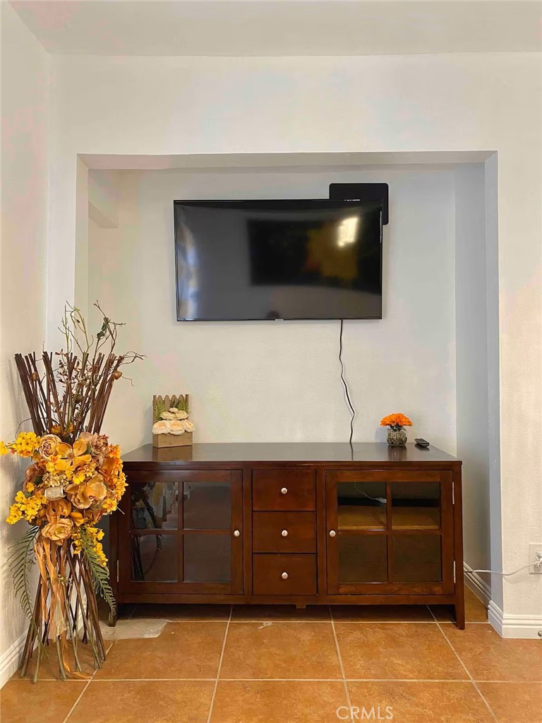 1364 East 61st Street Los Angeles, CA 90001 - Photo 8 of 32 a living room with furniture and a flat screen tv