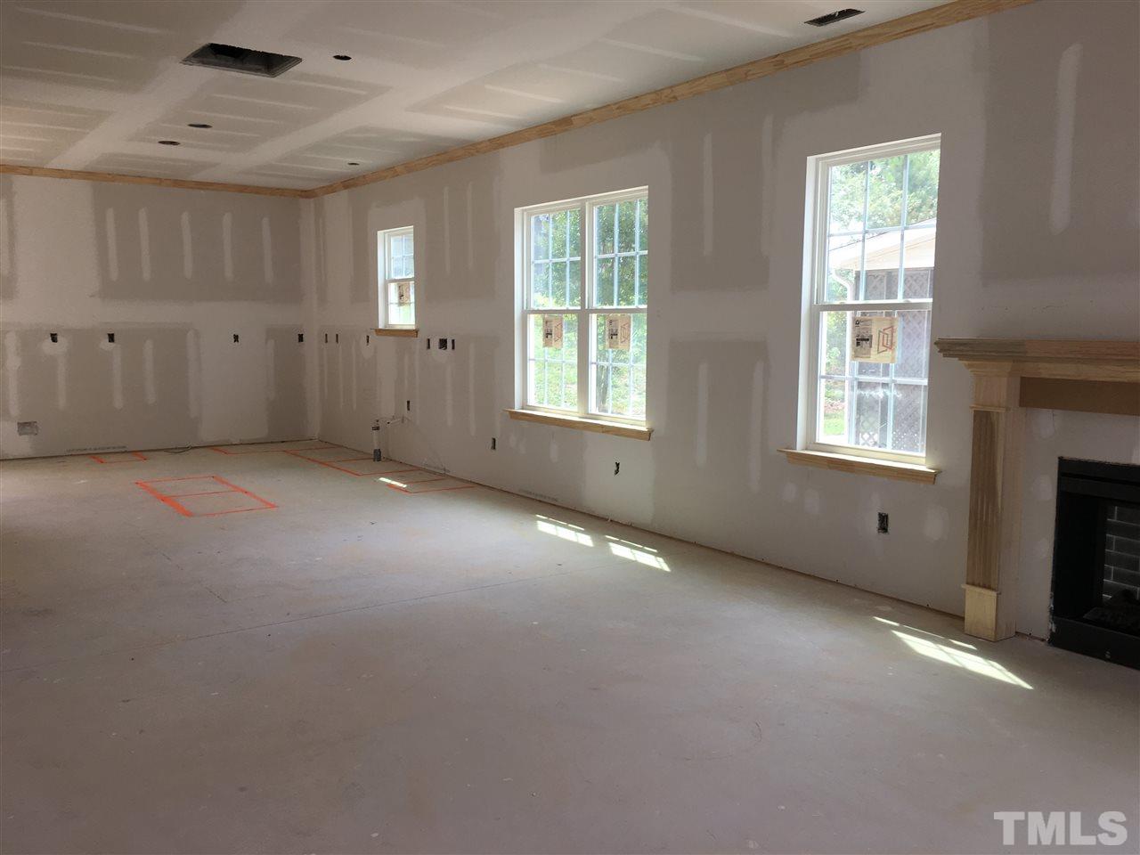 2520 Quarry Ridge Lane Raleigh, NC 27610 - Photo 4 of 12 a view of an empty room with a fireplace and a window