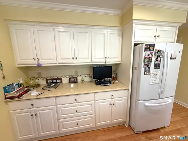 a kitchen with stainless steel appliances white cabinets and a refrigerator
