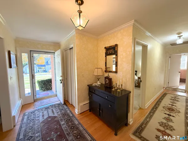 a bedroom with furniture and a rug