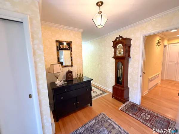 a view of a hallway to a livingroom with furniture