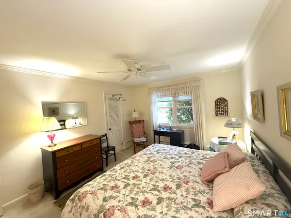 a bed room with a bed mirror and a window