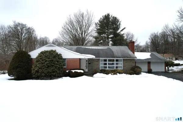 a view of house with a yard covered in snow