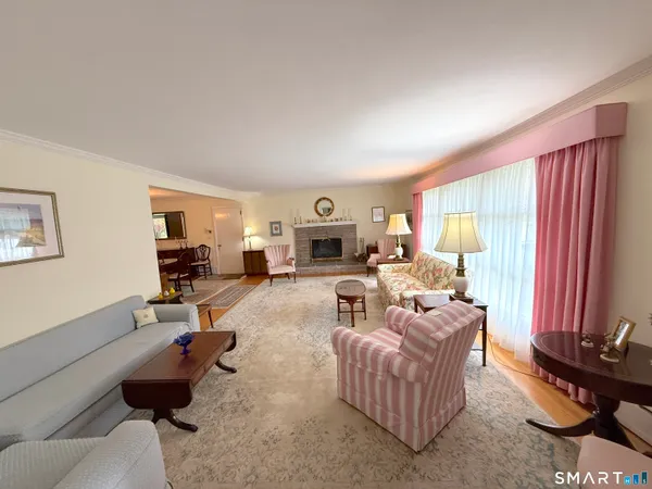 a living room with furniture a rug and a window