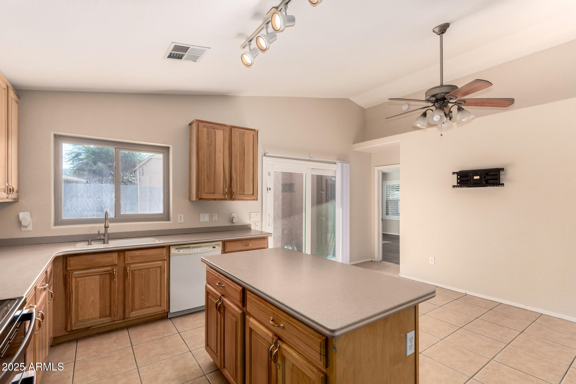 2513 West Carter Road Phoenix, AZ 85041 - Photo 12 of 27 a kitchen with a sink stove and cabinets
