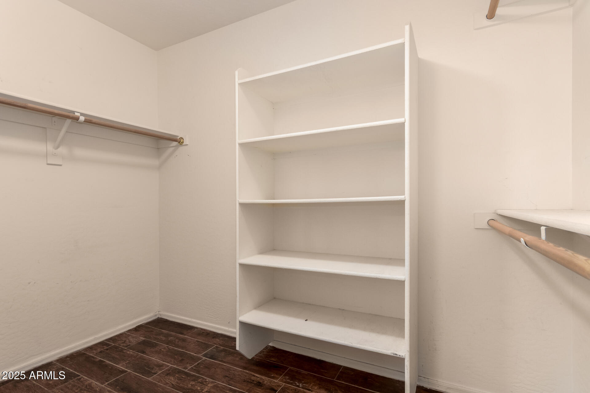 2513 West Carter Road Phoenix, AZ 85041 - Photo 16 of 27 a view of an empty walk in closet