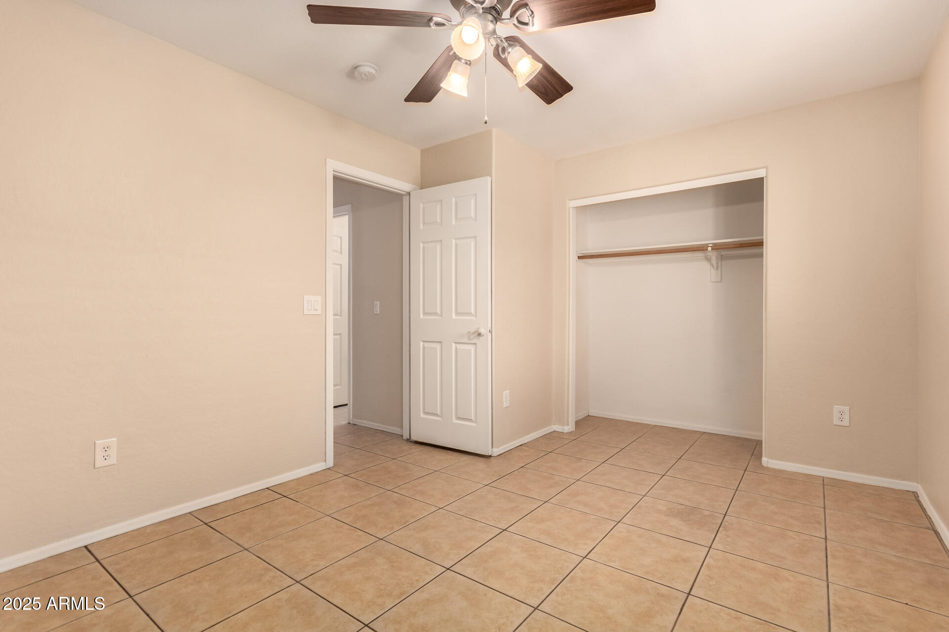 2513 West Carter Road Phoenix, AZ 85041 - Photo 17 of 27 an empty room with fan and windows