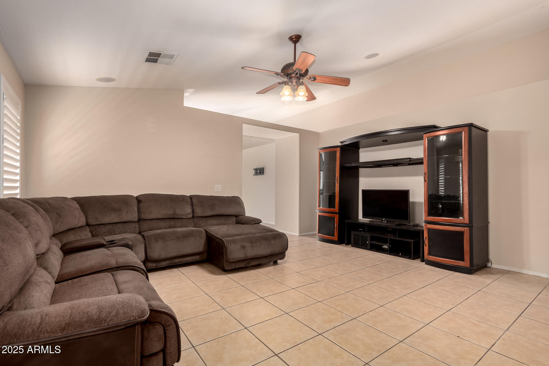 2513 West Carter Road Phoenix, AZ 85041 - Photo 3 of 27 a living room with furniture and a flat screen tv