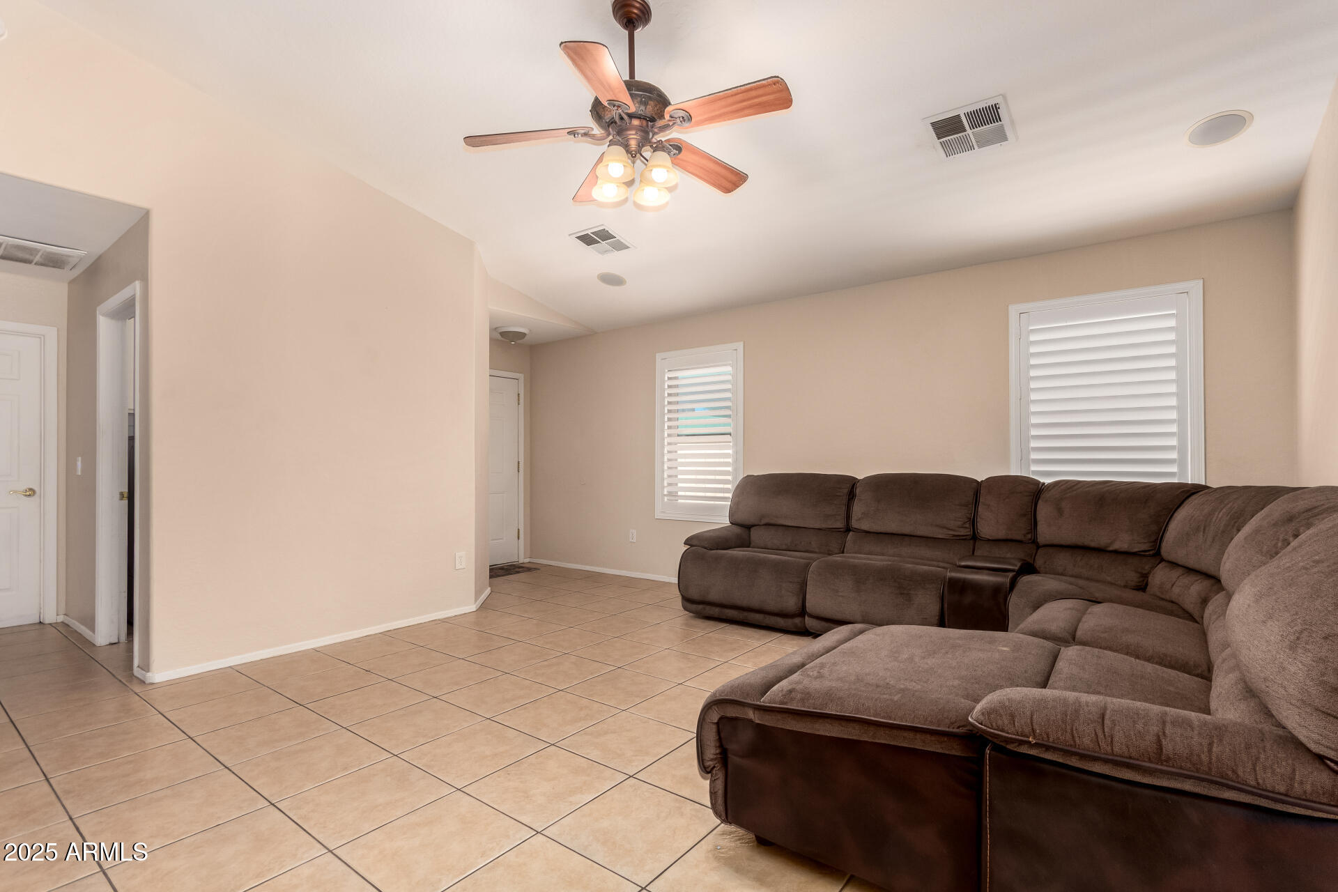 2513 West Carter Road Phoenix, AZ 85041 - Photo 10 of 27 a living room with furniture and a ceiling fan