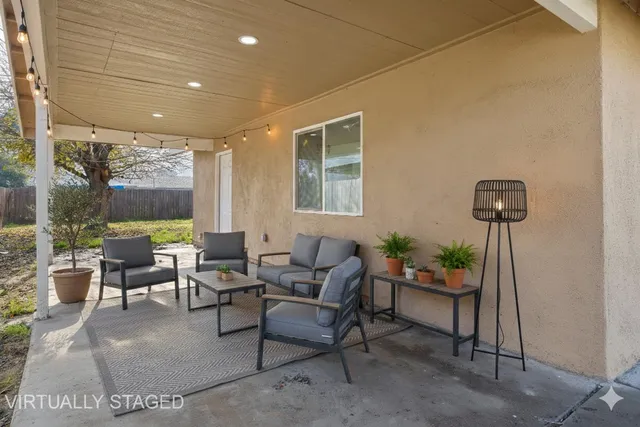 a living room with furniture and a potted plant