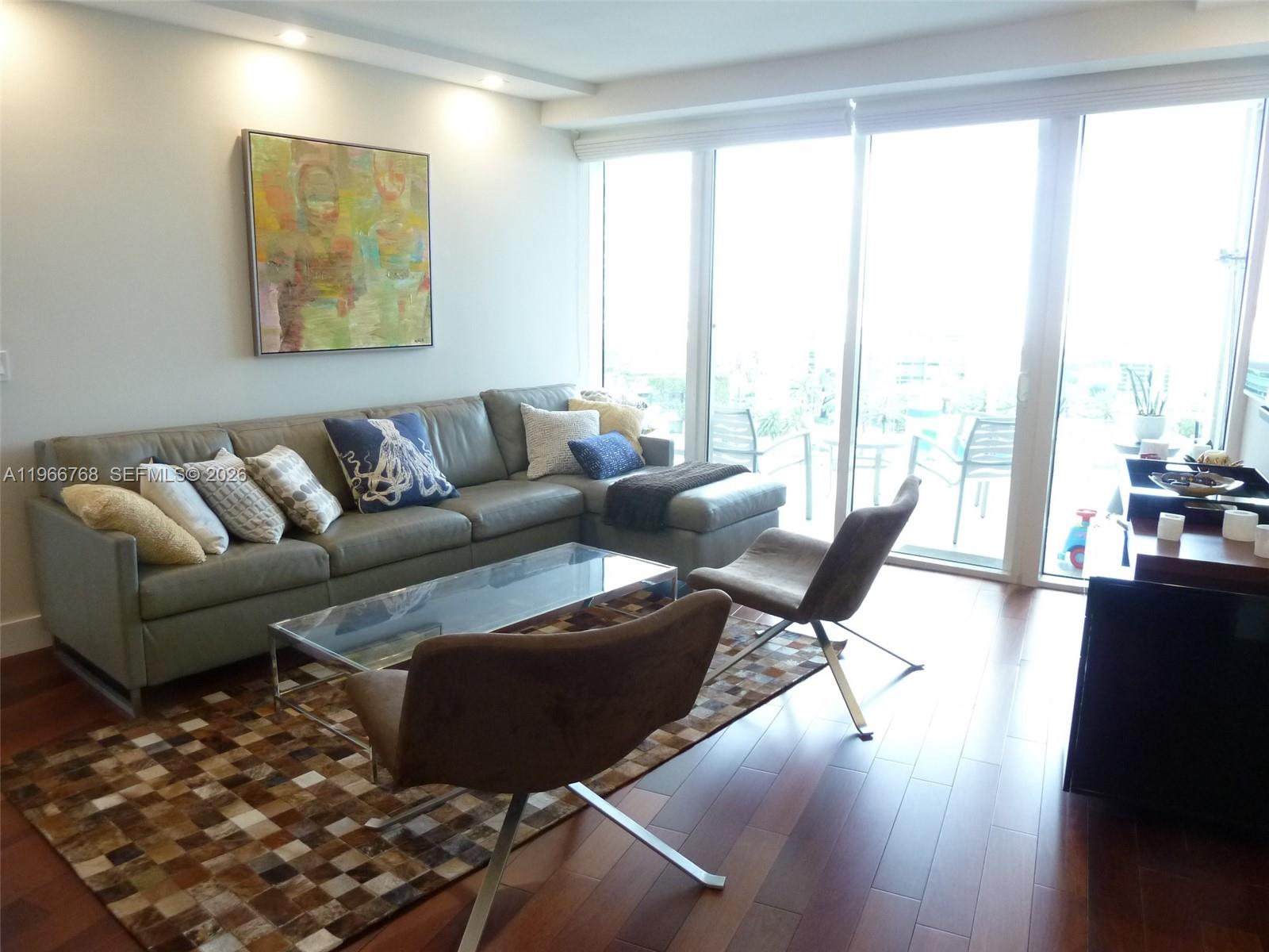 400 Alton Road, Unit 905 Miami Beach, FL 33139 - Photo 11 of 30 a living room with furniture and a large window