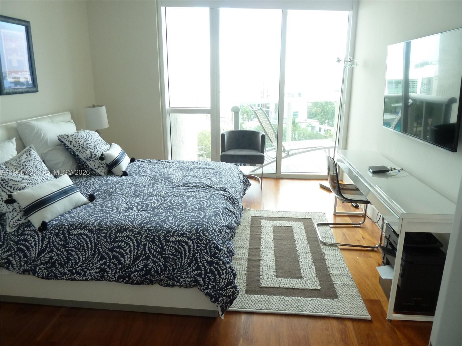 400 Alton Road, Unit 905 Miami Beach, FL 33139 - Photo 15 of 30 a living room with a bed furniture and a large window