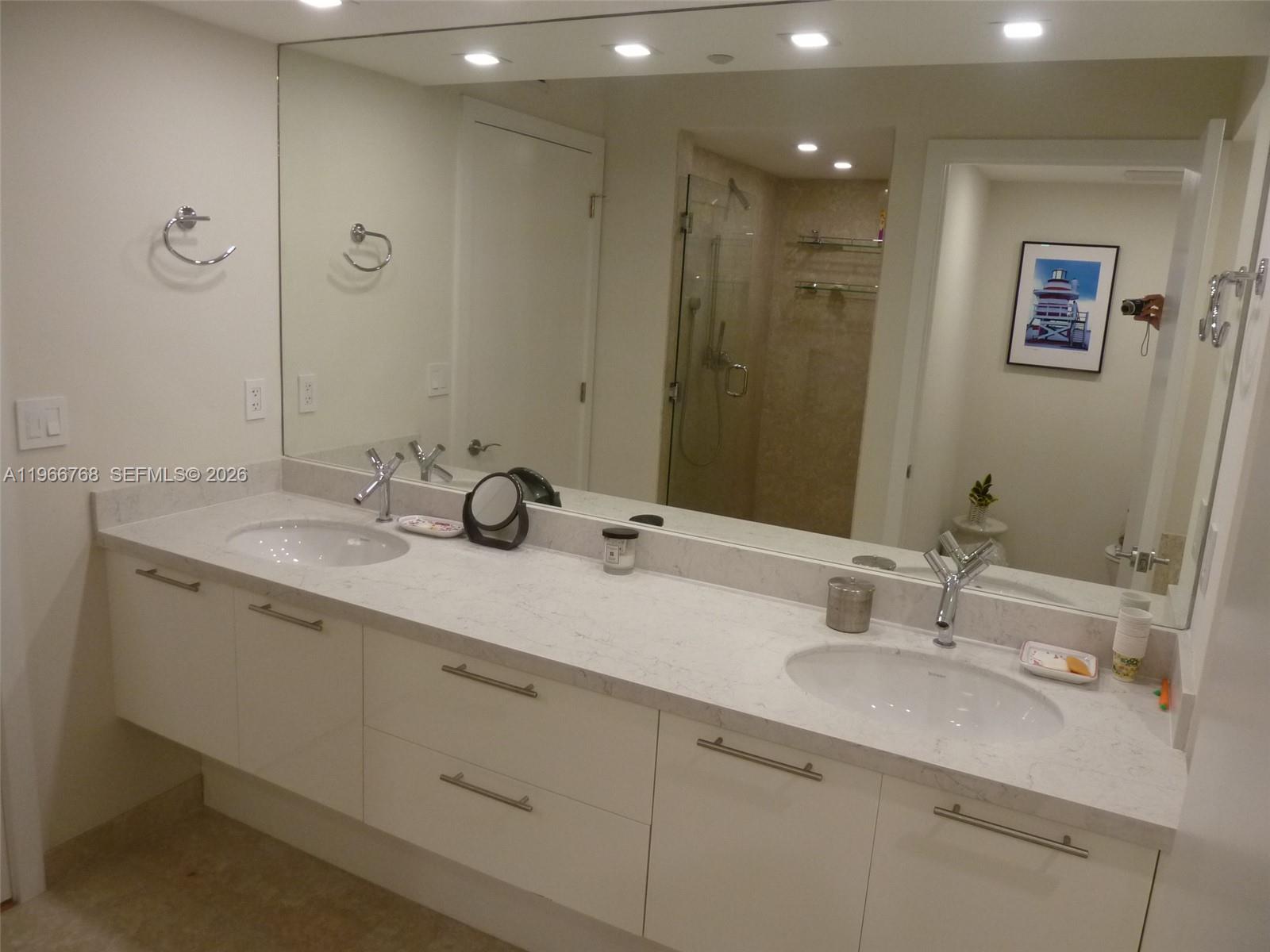 400 Alton Road, Unit 905 Miami Beach, FL 33139 - Photo 16 of 30 a bathroom with double sink and a mirror