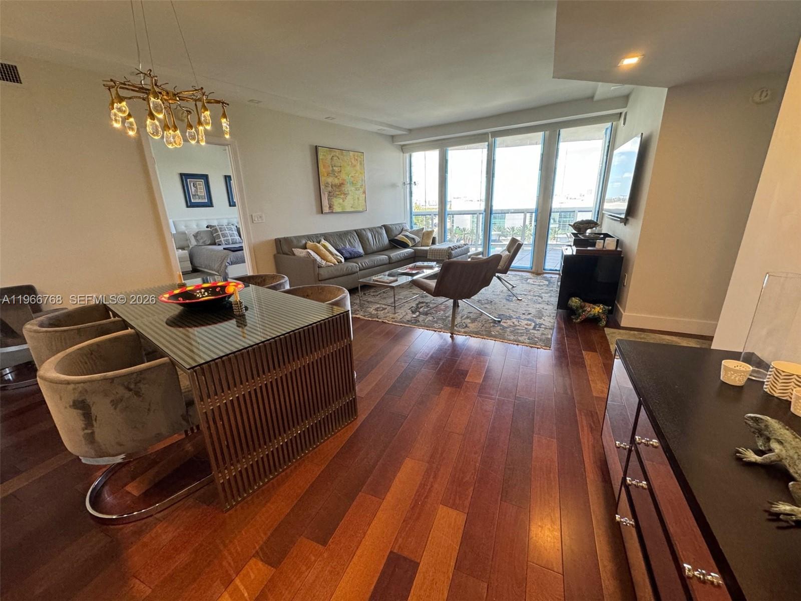 400 Alton Road, Unit 905 Miami Beach, FL 33139 - Photo 2 of 30 a living room with furniture and wooden floor