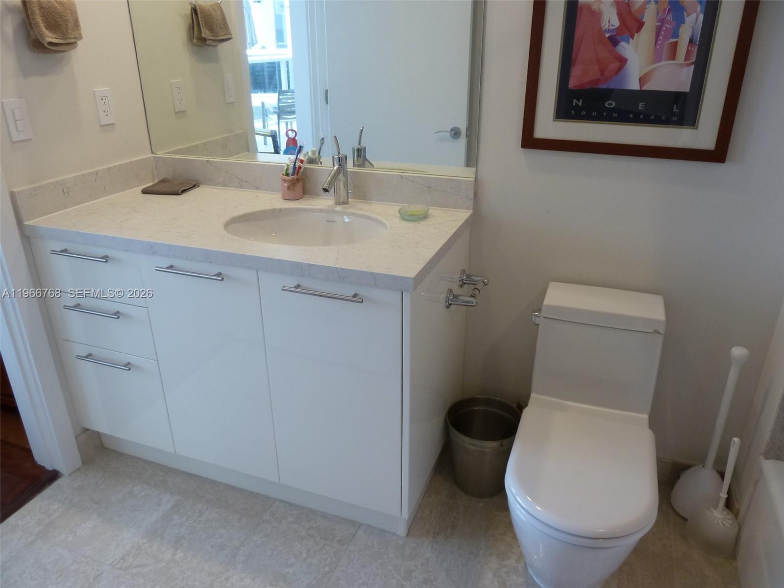 400 Alton Road, Unit 905 Miami Beach, FL 33139 - Photo 21 of 30 a bathroom with a toilet sink and mirror