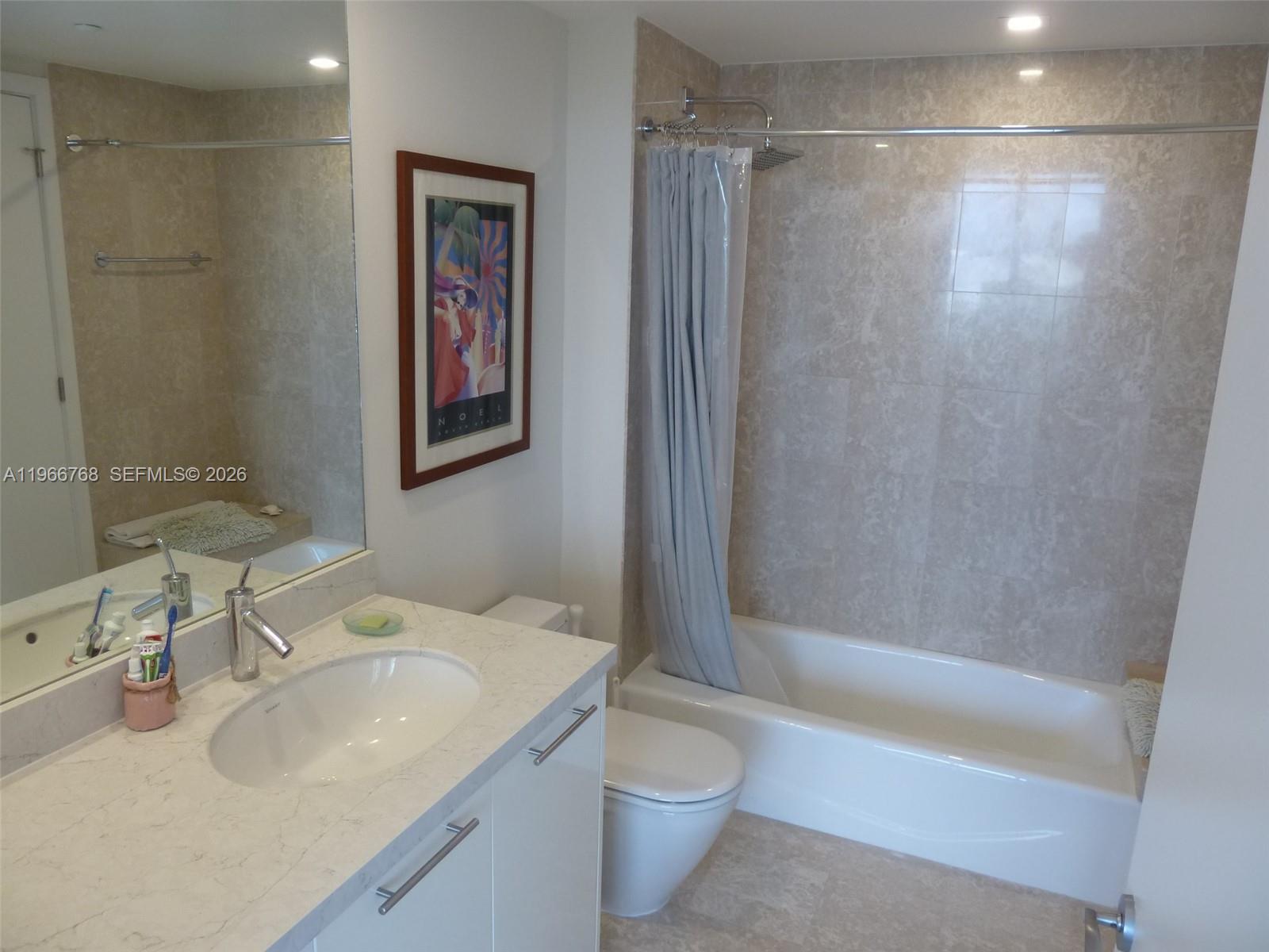 400 Alton Road, Unit 905 Miami Beach, FL 33139 - Photo 22 of 30 a bathroom with a sink toilet and shower