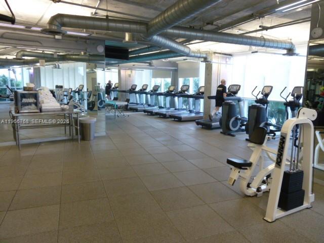 400 Alton Road, Unit 905 Miami Beach, FL 33139 - Photo 29 of 30 a room with gym equipment and windows