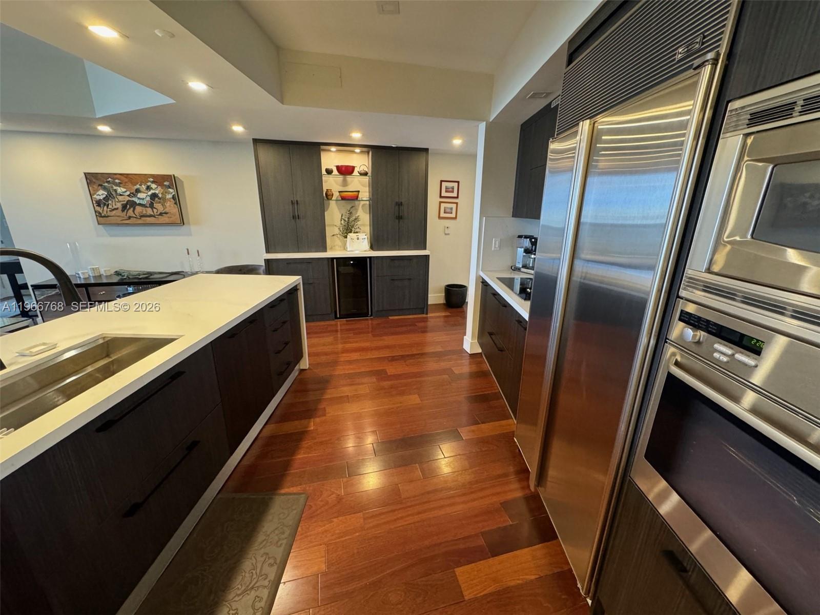 400 Alton Road, Unit 905 Miami Beach, FL 33139 - Photo 6 of 30 a large kitchen with stainless steel appliances a refrigerator and a sink