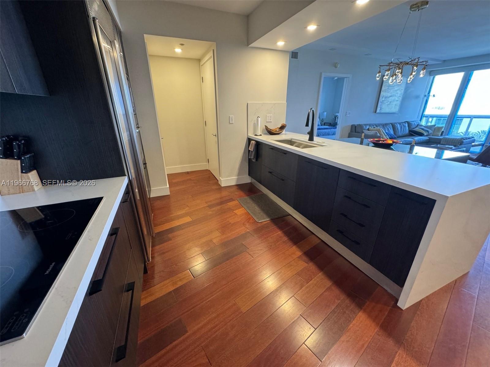 400 Alton Road, Unit 905 Miami Beach, FL 33139 - Photo 7 of 30 a kitchen with a sink a counter top space and cabinets
